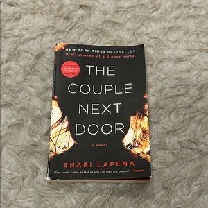 The Couple Next Door by Shari Lapena - Black and Red Cover